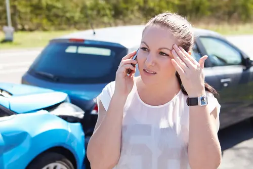 Woman On Phone After Car Accident