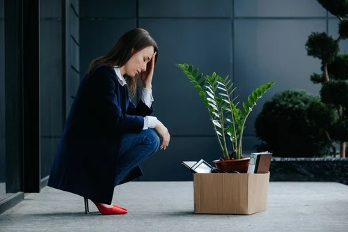 A frustrated woman with office supplies lost her job after a car accident.