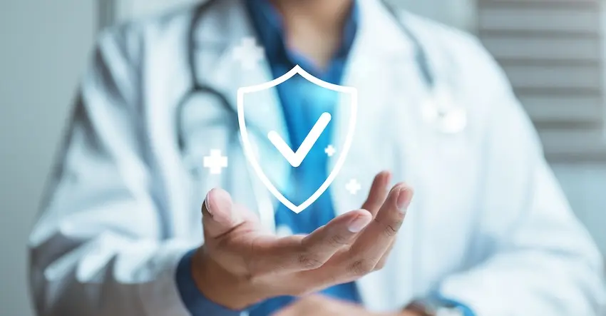 A healthcare provider in a white coat is presenting a digital shield icon representing accident injury coverage and medical protection benefits in Atlanta.