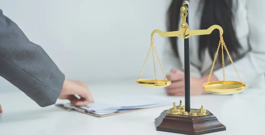 Motor vehicle accident legal representation with the scales of justice and case documentation review.