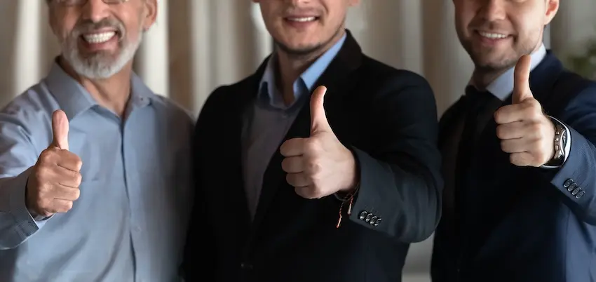 Three male lawyers are giving a thumbs up after helping clients with a back injury problem at Atlanta Accident Lawyers within the Metro Atlanta area.