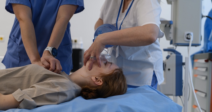 A medical team is providing emergency care to a female car accident victim on a hospital bed during trauma assessment in Atlanta.