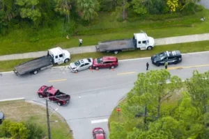 Atlanta Car accident Lawyer concept image. An aerial image of a rear-end car accident, with two cars pulled off to the side of the road and widespread debris from the impact.
