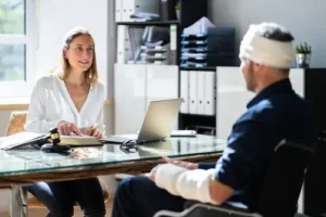 Image of a traumatic brain injury lawyer provider conducting a consultation on a patient recovering from a traumatic brain injury, including assessment of mood swings and blurred vision.