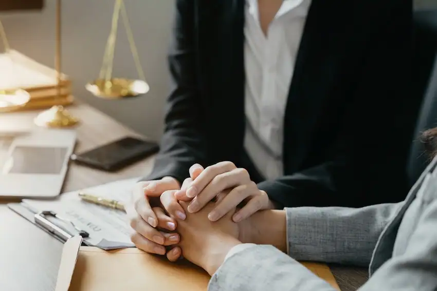 A personal injury lawyer holding a client's hand through a personal injury case.