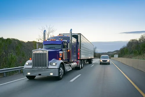 Semi truck and car on the highway